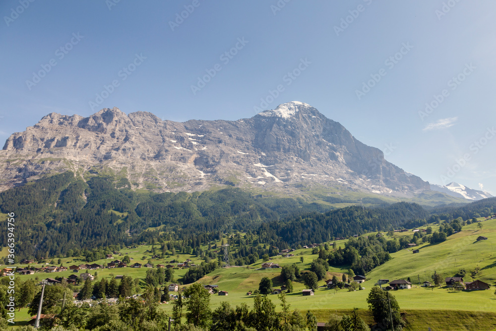 Green Swiss meadows and the North face of the Eiger mountain of the Bernese Alps, Grindelwald, Switzerland