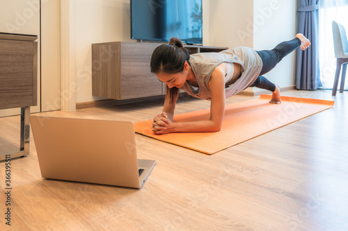 Fit Asian woman workout exercise at home during Covid 19 