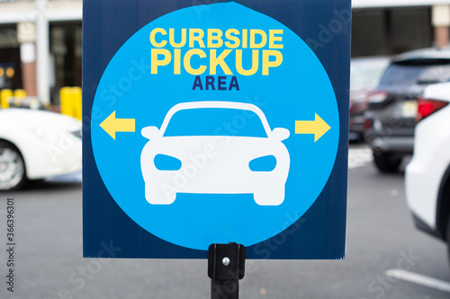 Curbside pick up sign in blue with a picture of a car