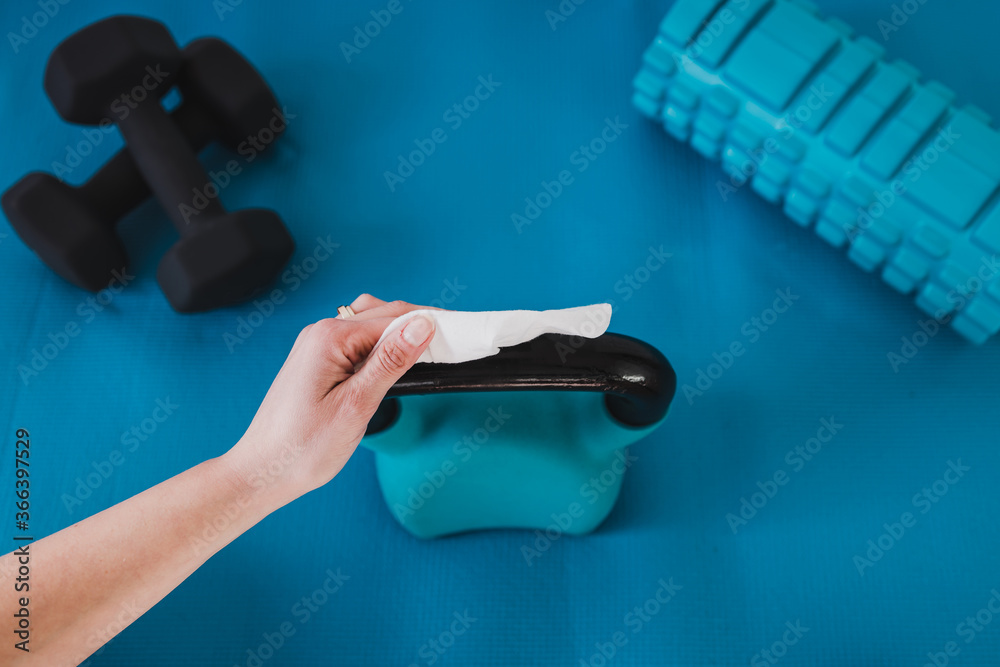 the new normal after covid19, hand cleaning gym equipment with