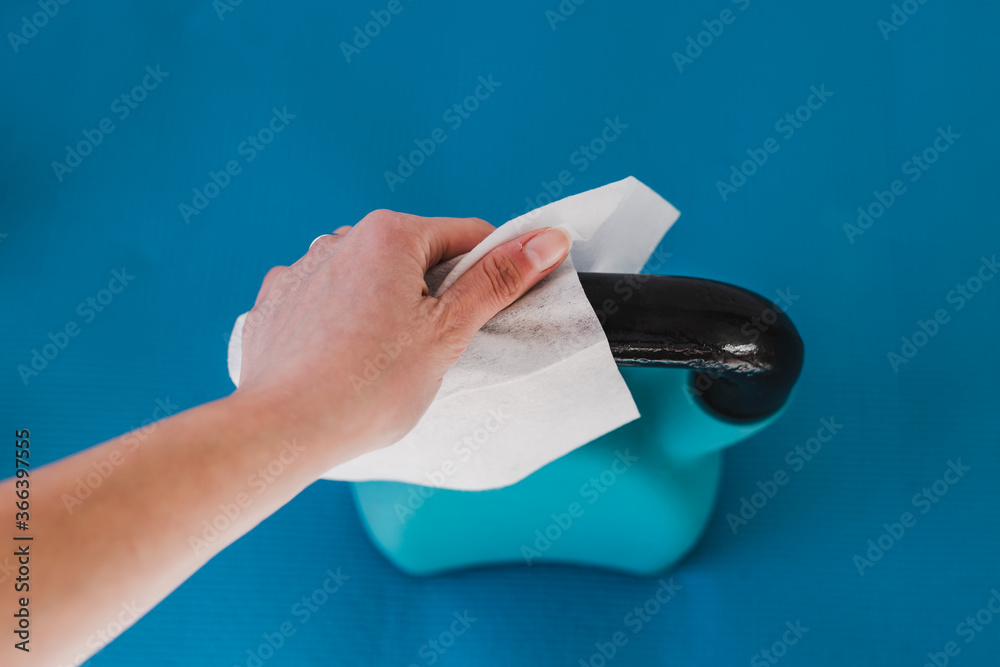 the new normal after covid19, hand cleaning gym equipment with