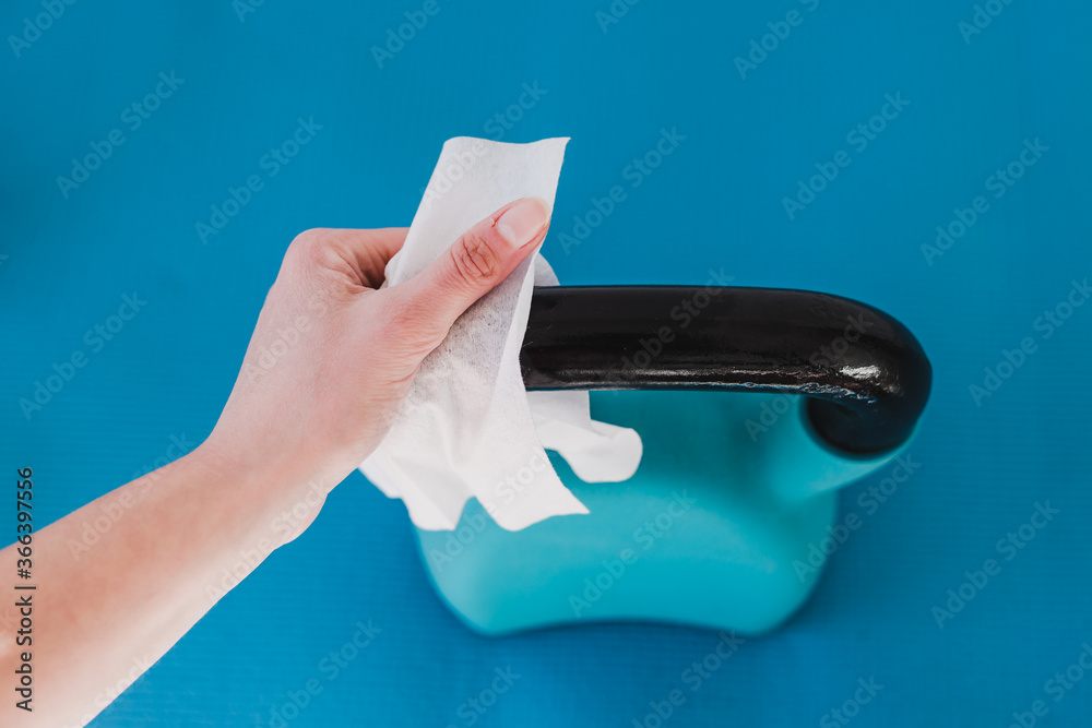 the new normal after covid19, hand cleaning gym equipment with