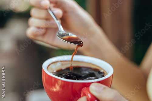 hand use spoon mix coffee in the morning.