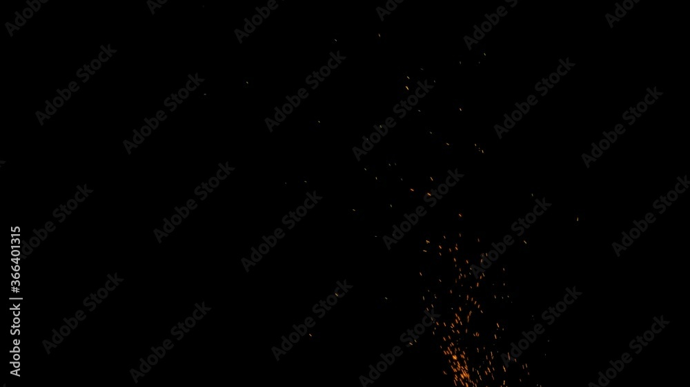 Spark particles of bonfire on black background, sparks rising from burning charcoal
