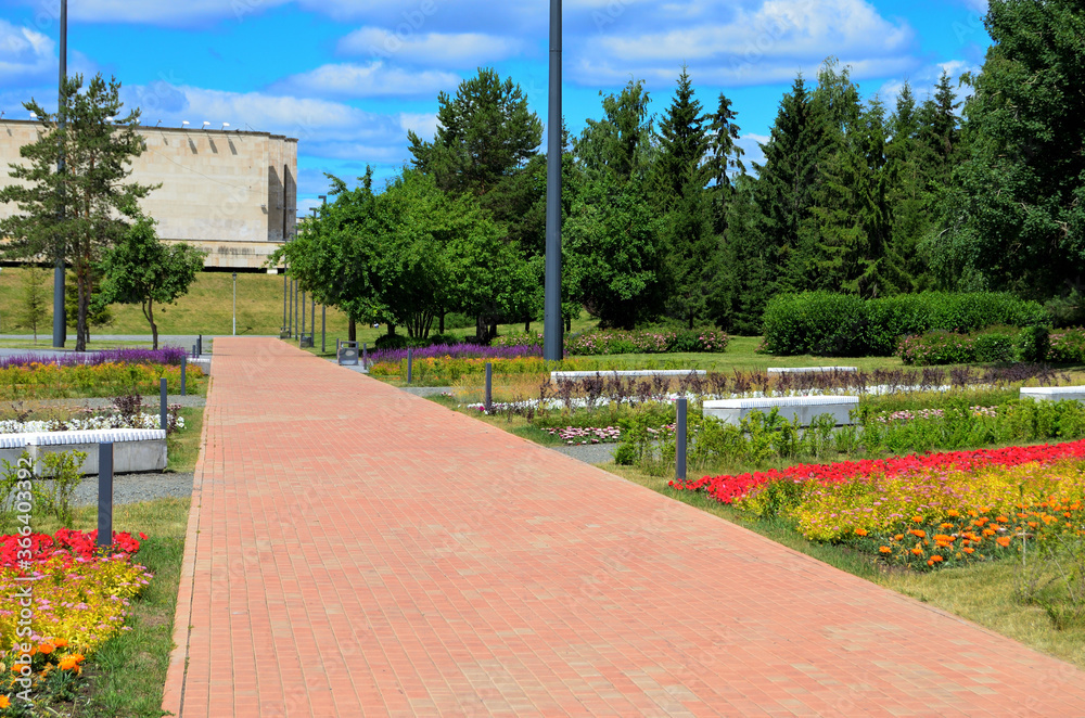red paving path along flower beds with different colors