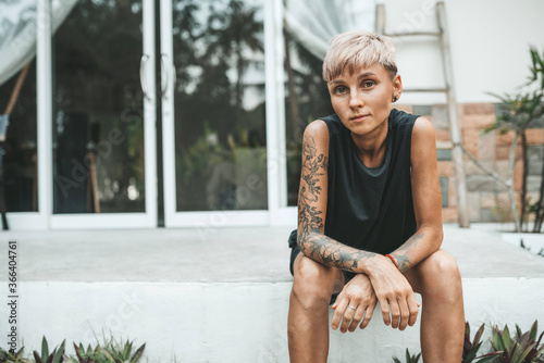 Short haicut woman sitting at her house outdoors photo