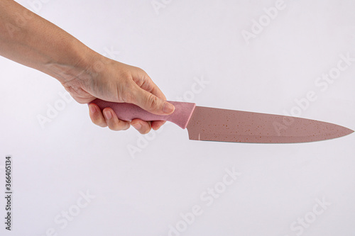 Hand is holding a kitchen kinfe isolated on a white background photo