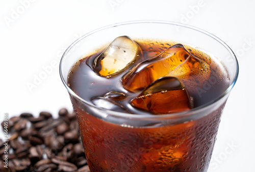 Obraz na plátně Cold coffee and coffee beans in a glass on a white background