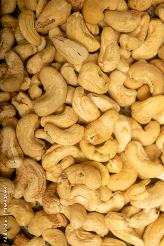 Fototapeta premium Cashew nuts scattered surface texture. Close up.