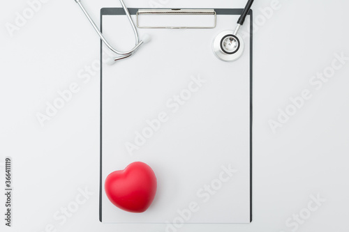 Top view of Stethoscope, Document Board, Pen, Heart shaped ball  on white background and copy space