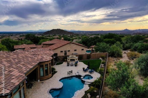 A high definition aerial view of a a home in Arizona with dramatic landscaping during sunset. photo