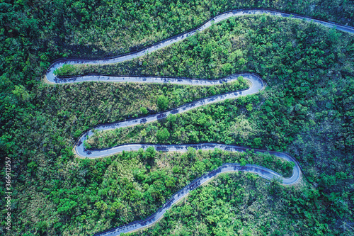 Winding Road Aerial Photography - Road in forest on the mountain birds eye view use the drone photography, with sunlight and shadow in afternoon, shot in Toucheng Township, Yilan, Taiwan. photo