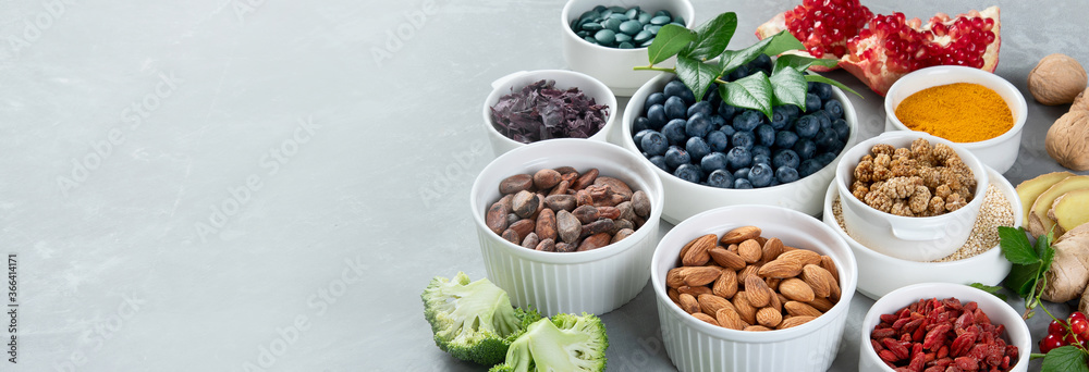 Fotografie Various superfoods on grey background.