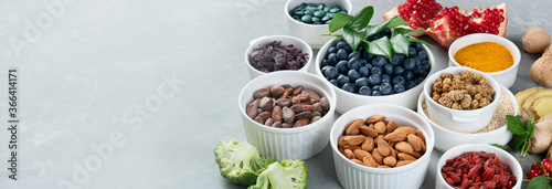 Fotografie Various superfoods on grey background.
