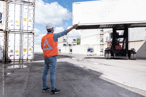 Photography Shipping business background, worker is command to crane loading many cargo container ship and airway bill around the world, business to make export and import, logistics transportation concept