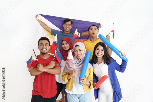 excited asian young supporter holding philippines flag over white background