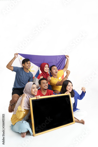 group of excited asian filipino supporter holding philippines flag and blank blackboard