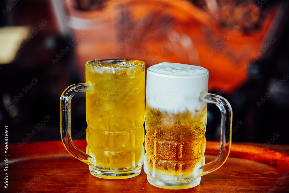 Butter beer and Chrysanthemum Tea in tall glass on wood table. Butter beer and Chrysanthemum Tea in tall glass on wood table.