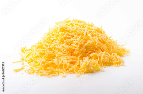 Grated hard cheese on a white plate. Russian cheese, Dutch, parmesan heap grated on a white plate in a close-up top and top view