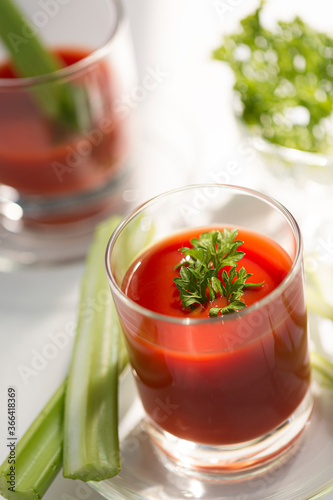 Tomato juice with celery, parsley healthy cocktail for breakfast, close up
