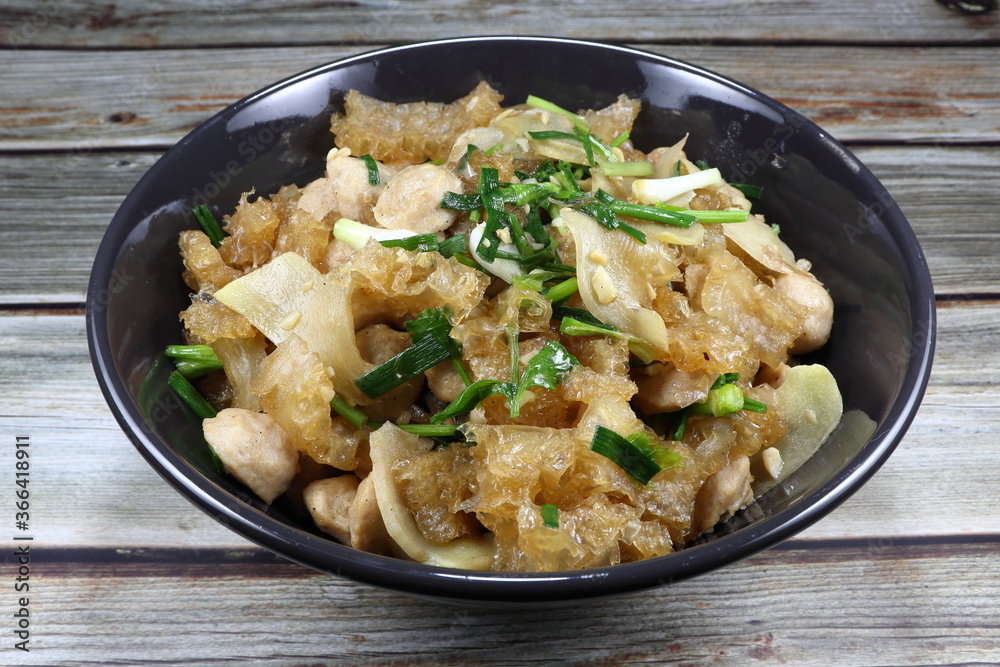 Traditional fried and stirred cutting pork skin with pork meat ball and chopped spring onion in Chinese style. Famous luxury ancient menu in Asia restaurant. Traditional fried and stirred cutting pork skin with pork meat ball and chopped spring onion in Chinese style. Famous luxury ancient menu in Asia restaurant.