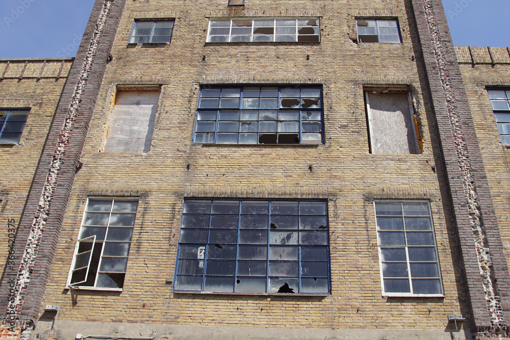 Facade of an old factory building in the Dutch city of Alkmaar with broken windows. Netherlands, May        