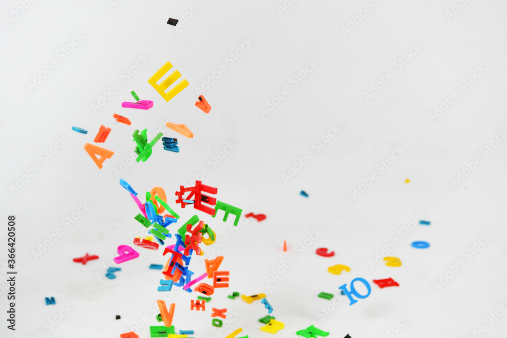 multicolored letters in flight on a white background multicolored letters in flight on a white background