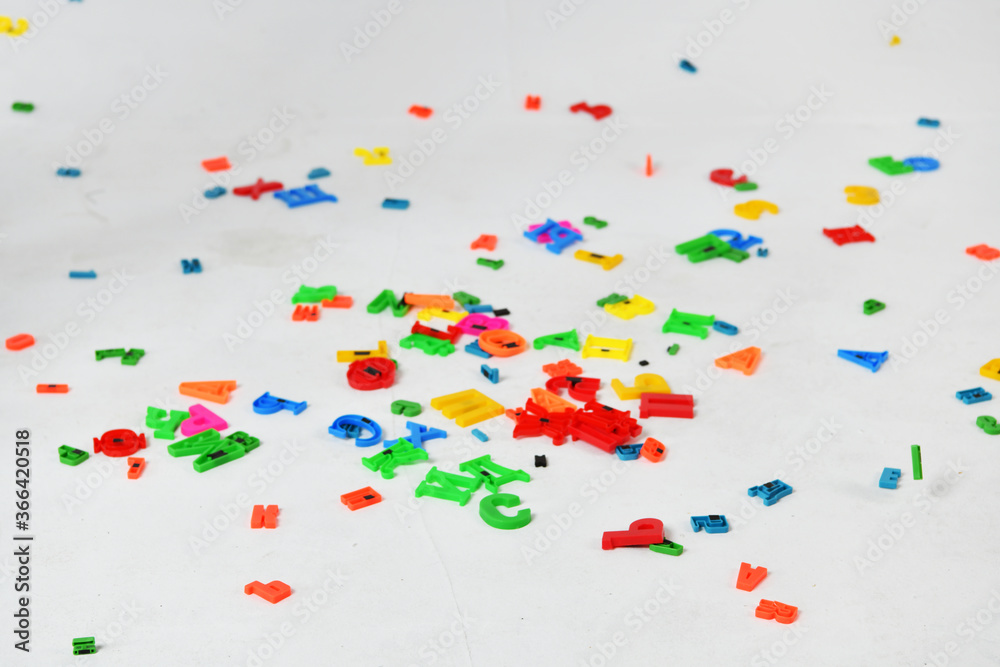 multicolored letters in flight on a white background multicolored letters in flight on a white background