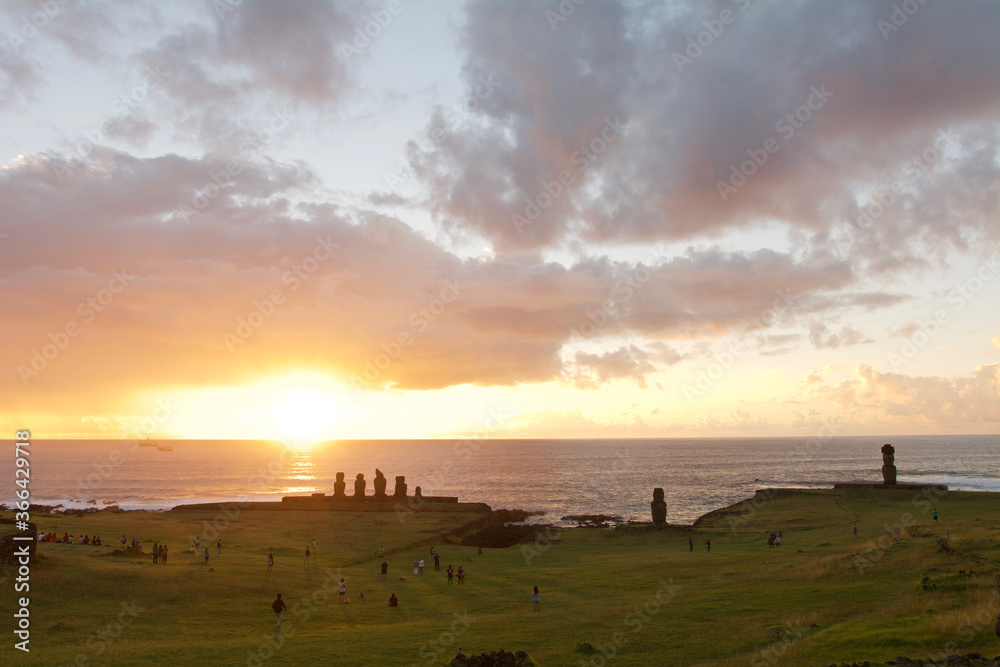 People and Moai Statues Watch Easter Island Sunset on Easter Island.