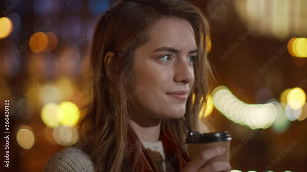 Pretty woman enjoying coffee outdoor. Beautiful girl holding paper cup on street Pretty woman enjoying coffee outdoor. Beautiful girl holding paper cup on street