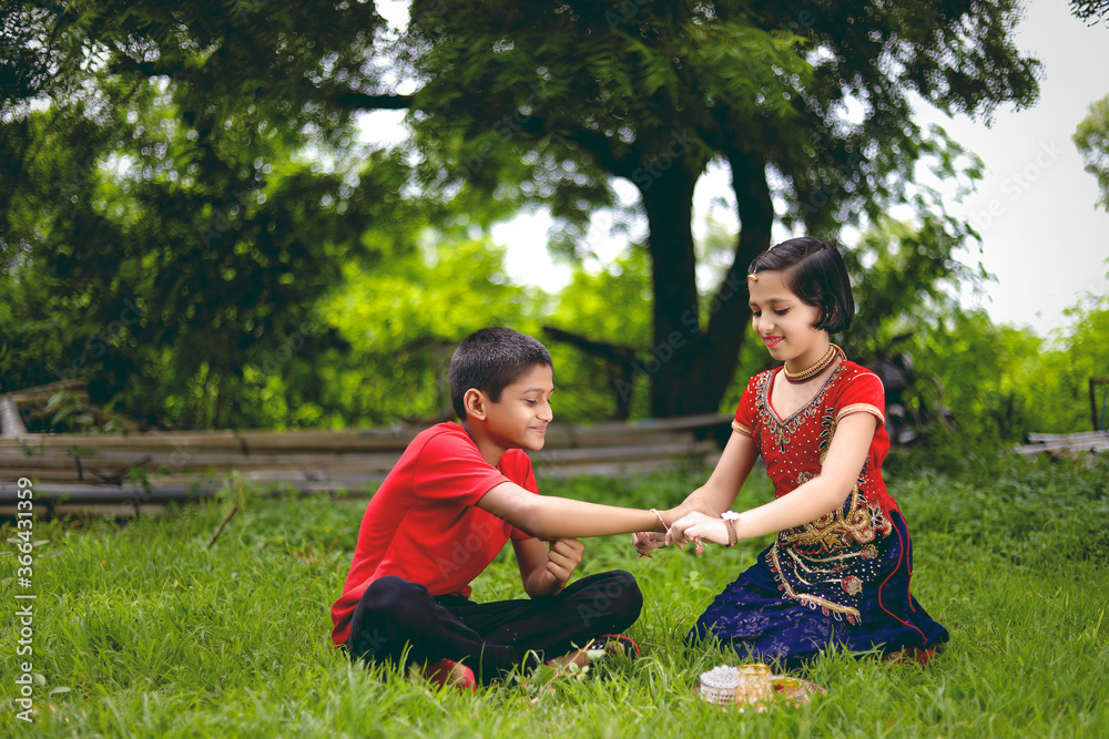 Young indian brother and sister celebrating raksha bandhan festival at home Young indian brother and sister celebrating raksha bandhan festival at home