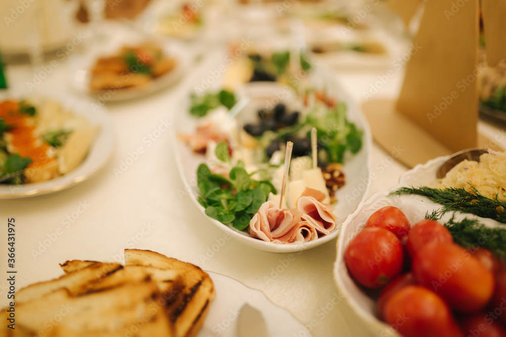 Table with food and drink on wedding. Served and decorated table in restaurant Table with food and drink on wedding. Served and decorated table in restaurant