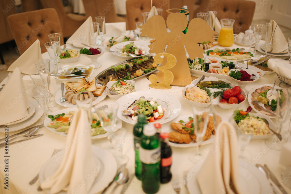 Table with food and drink on wedding. Served and decorated table in restaurant Table with food and drink on wedding. Served and decorated table in restaurant