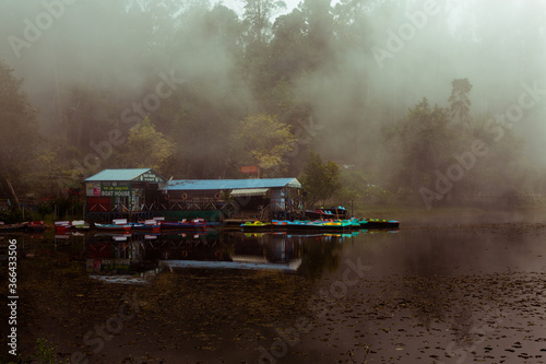 Misty lake view with boat house photo