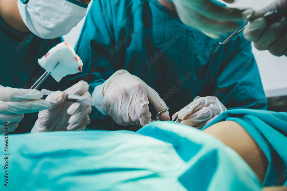 Medical team of surgeons in hospital doing invasive surgical interventions. Surgery operating room with electrocautery equipment for cardiovascular emergency surgery center. Medical team of surgeons in hospital doing invasive surgical interventions. Surgery operating room with electrocautery equipment for cardiovascular emergency surgery center.