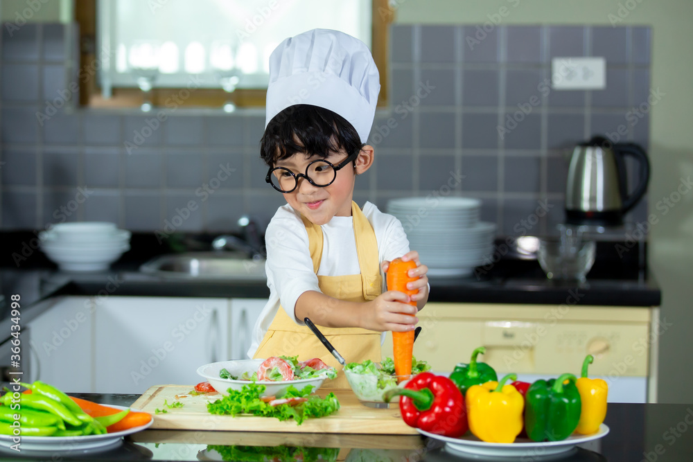Happy Asian boy having breakfast with preparing food in the kitchen. Happy Asian boy having breakfast with preparing food in the kitchen.