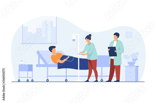 Patient lying in bed during intensive therapy isolated flat vector illustration. Cartoon doctor with clipboard and nurse with dropper. Hospital room, therapy and healthcare concept