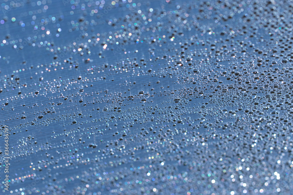 drops of water shine in the sun as a background drops of water shine in the sun as a background