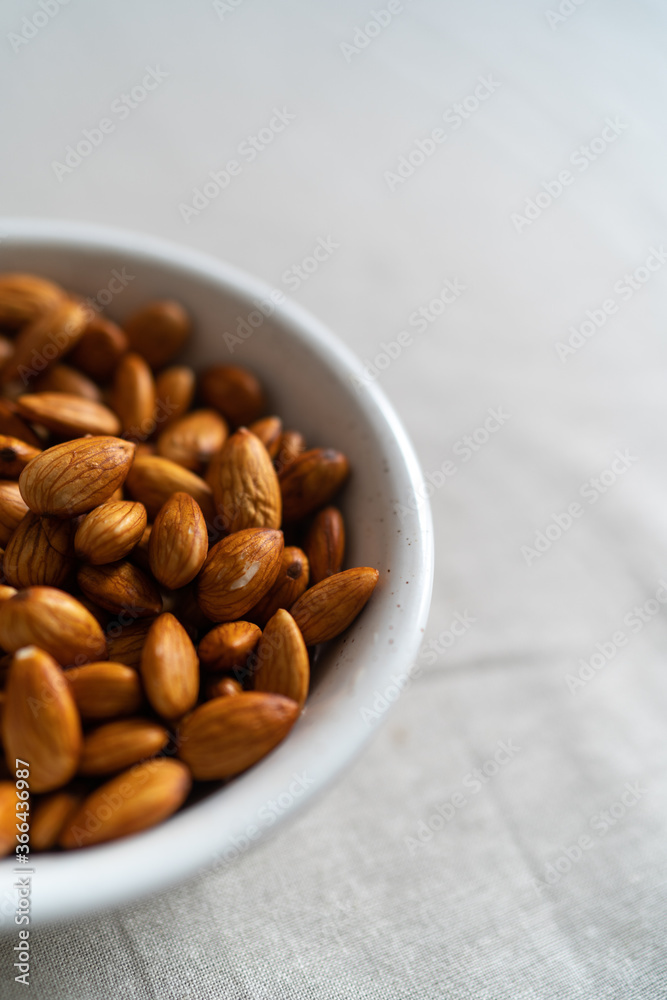 Plate with almonds on a light surface Plate with almonds on a light surface