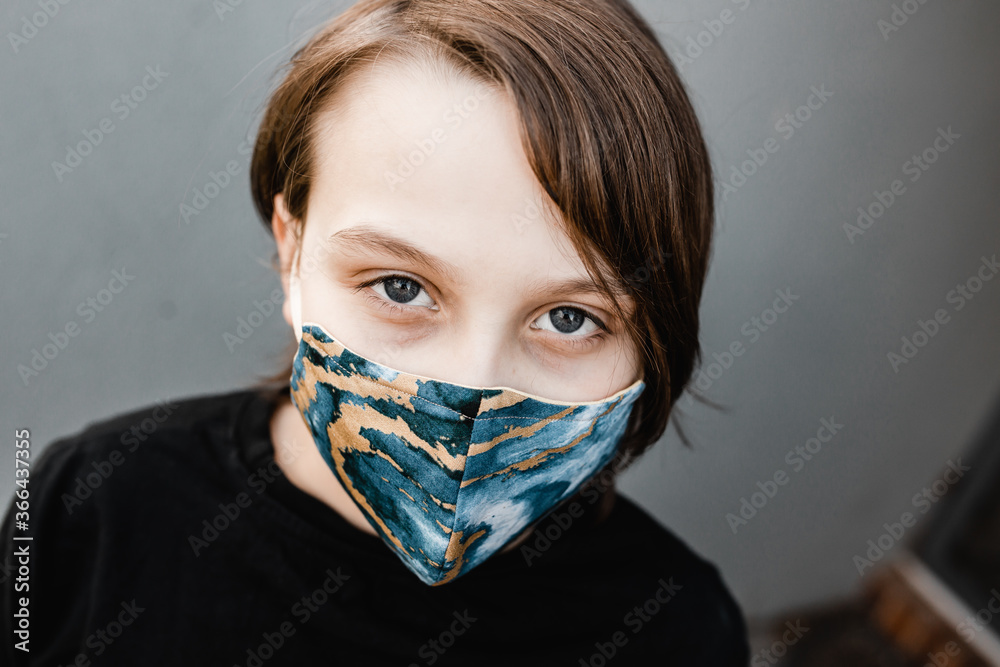 boy child wearing fabric masks during the corona COVID-19 pandemic, masks are now compulsory.