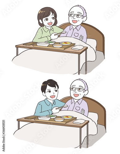 老齢男性の食事を手伝う家族