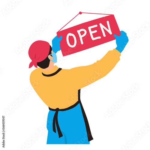 An employee of a store or restaurant hangs a sign open. Opening, reopening stores, shops, businesses after the pandemic. A retail worker wears a protective mask and gloves. A waiter holds a signboard.