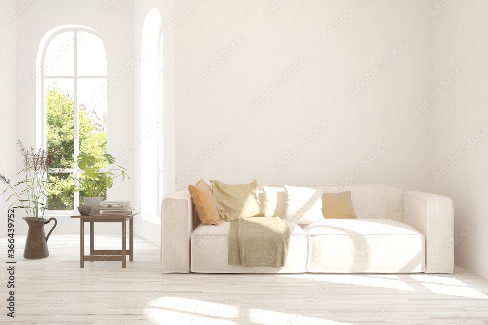 Fototapeta premium White living room with sofa and summer landscape in window. Scandinavian interior design. 3D illustration