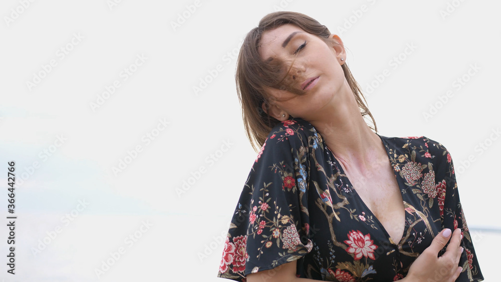 Young beautiful woman dancing on the seashore Young beautiful woman dancing on the seashore
