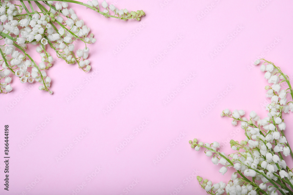 Beautiful lily of the valley flowers on pink background, flat lay. Space for text Beautiful lily of the valley flowers on pink background, flat lay. Space for text