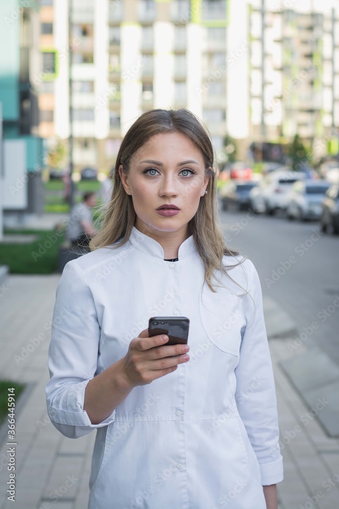 nurse with face mask calling on the phone