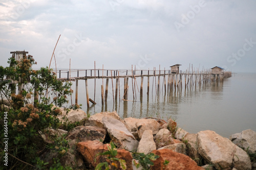 Langgai is made of bamboo and wood at Parit Jabar , Batu Pahat , Malaysia with beautiful sunrise as background. Soft focus, noise and grain due long exposure. photo