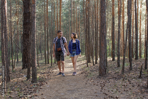 two tourists walking along a forest road