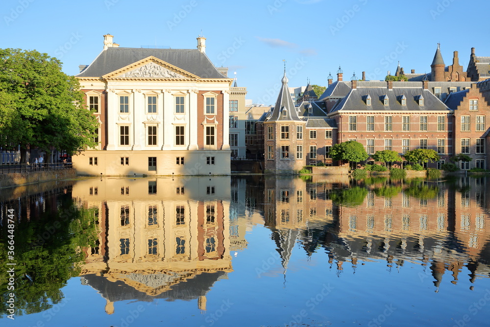 Reflections of the Mauritshuis and the Binnenhof (13 century gothic castle) on the Hofvijver lake, The Hague, Netherlands