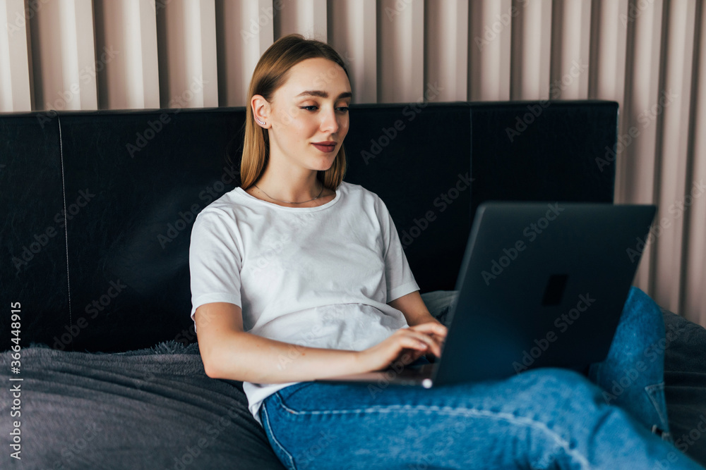 Pretty young woman using her laptop in bed Pretty young woman using her laptop in bed